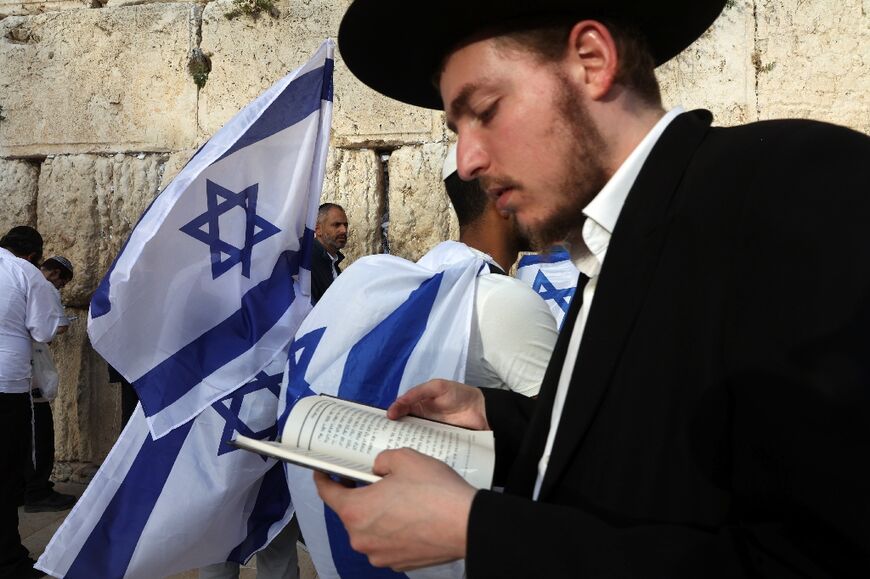 Ultra-Orthodox Jewish men pray at the Western Wall in the Old City of Jerusalem during the Israeli 'flags march' to mark "Jerusalem Day" on May 18 Jerusalem police and residents are bracing for extremist ministers and their supporters to rally on May 18 in an annual flag-waving march commemorating Israel's capture of the Old City.