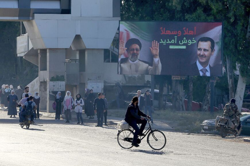 A Damascus billboard shows pictures of Iranian President Ebrahim Raisi and Syrian President Bashar al-Assad, on May 3, 2023