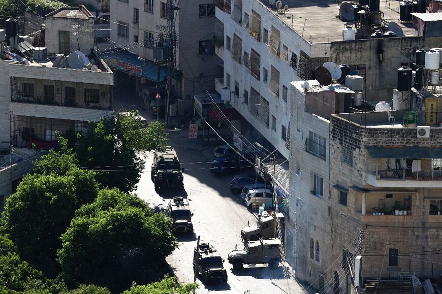 Israeli military vehicles converge on the Old City of Nablus in the hunt for the killers of a British-Israeli woman and her two daughters who died after an attack on their vehicle in the Jordan Valley last month