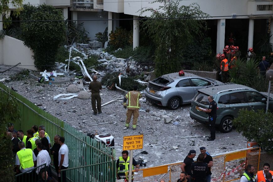 Israeli forces and rescuers deployed around a building in the central city of Rehovot where one person was killed by a Gaza rocket