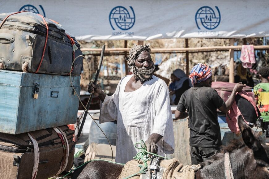 A man off loads a belongings of refugees from Sudan in Metema, Ethiopia on May 4
