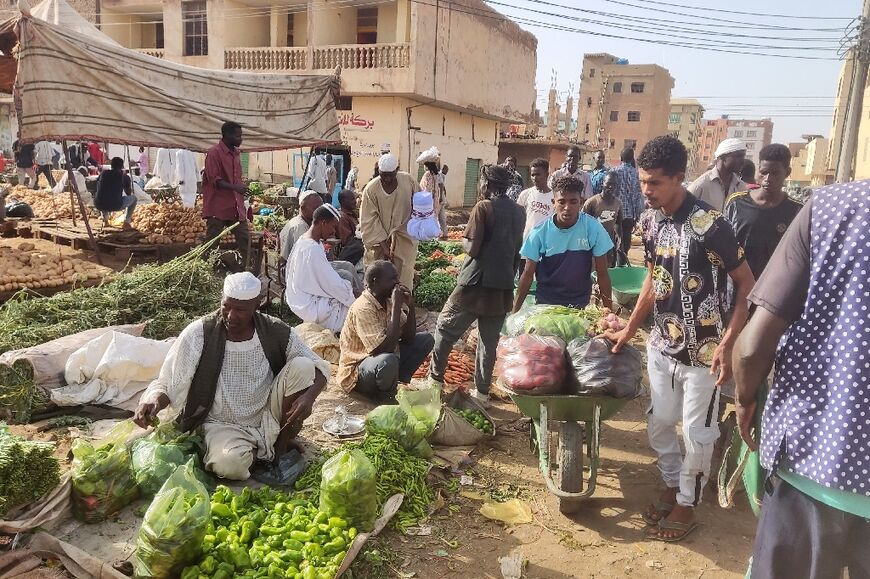 People sell fruits and vegetables in southern Khartoum on May 24, 2023 as sporadic artillery fire still echoed but residents said fighting had calmed 