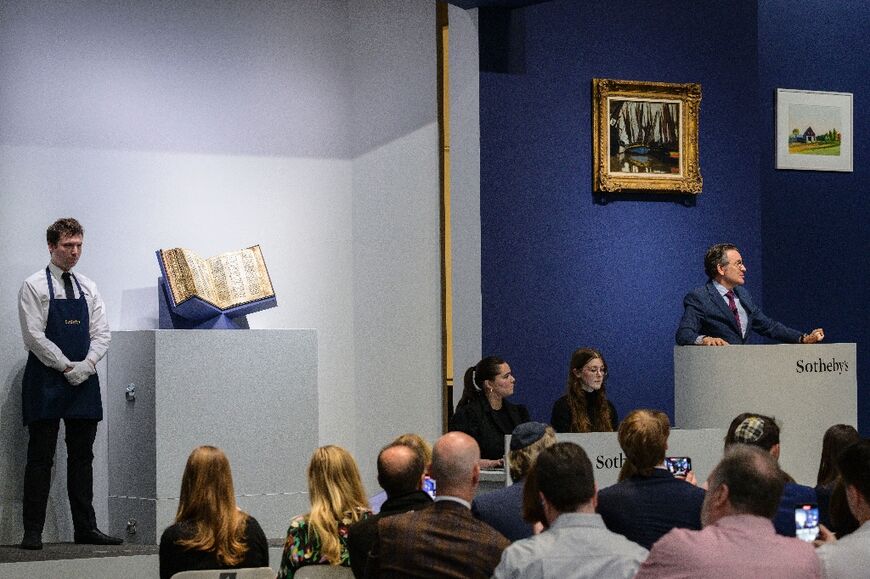 Sotheby’s auctioneer Benjamin Doller (R) takes bids during the Codex Sassoon sale at Sotheby’s in New York City on May 17, 2023