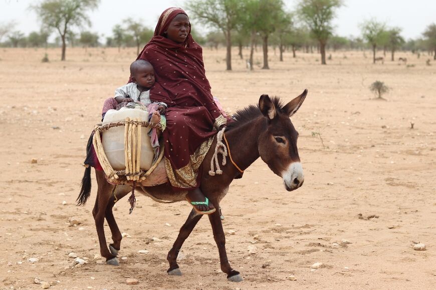 Sudanese refugees cross into Chad by donkey from the Darfur region which has seen some of the heaviest fighting in Sudan's war