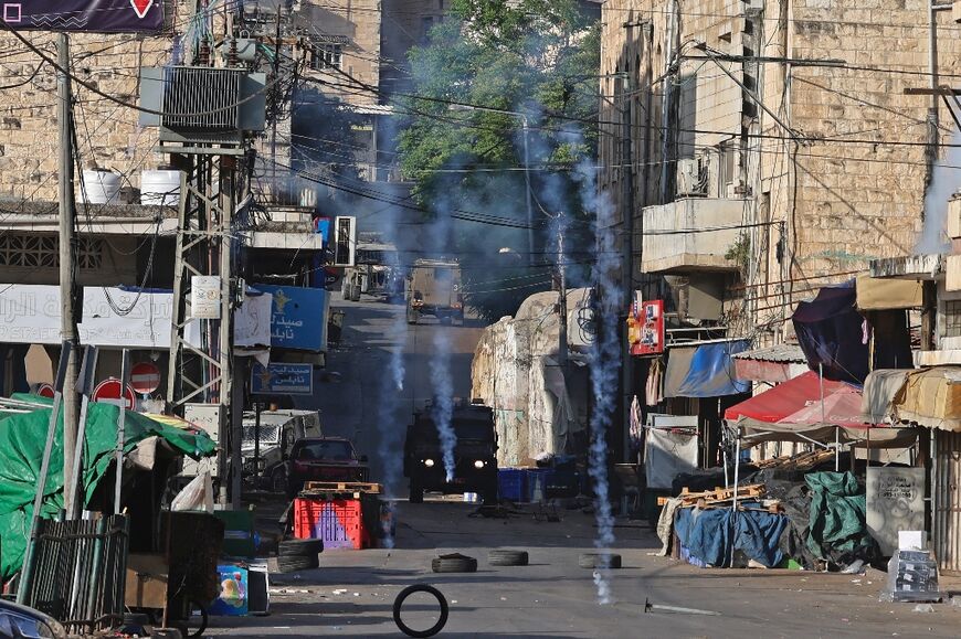 Israeli security forces fire tear gas to disperse Palestinians amid a raid in the occupied West Bank city of Nablus