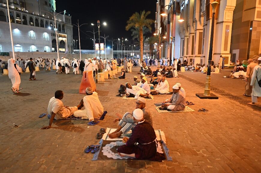 Pilgrims rest in the street after their exertions in the searing Saudi Arabian heat