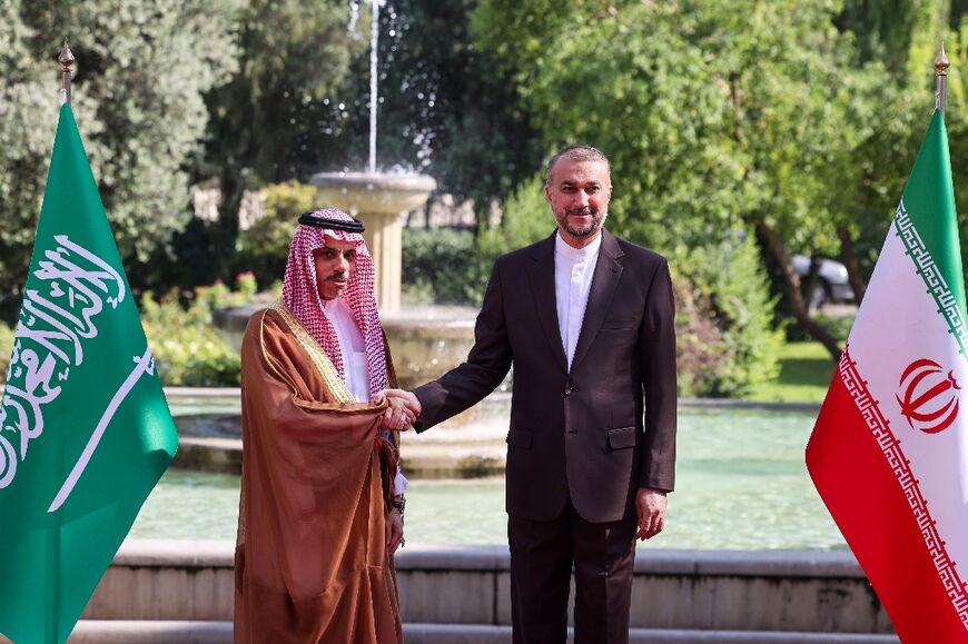 Iran's Foreign Minister Hossein Amir-Abdollahian (R) shakes hands with his Saudi counterpart Faisal bin Farhan (L) in Tehran 