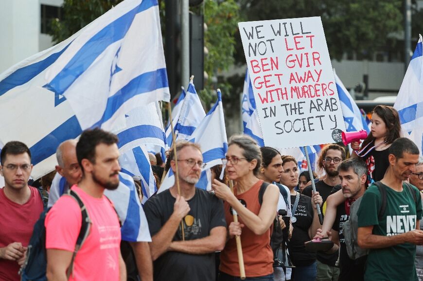 Protesters in Tel Aviv with signs criticising government inaction over a soaring crime wave that has affected the Arab minority