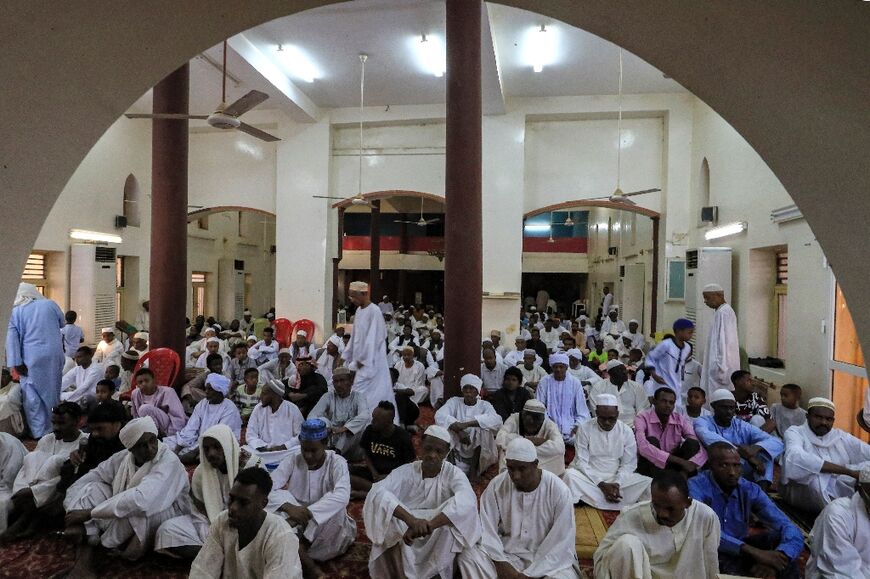 Muslim worshippers pray on April 21, 2023, the first day of Eid al-Fitr, which marks the end of the holy fasting month of Ramadan, at al-Hara al-Rabaa Mosque in the Juraif Gharb neighbourhood of Khartoum 