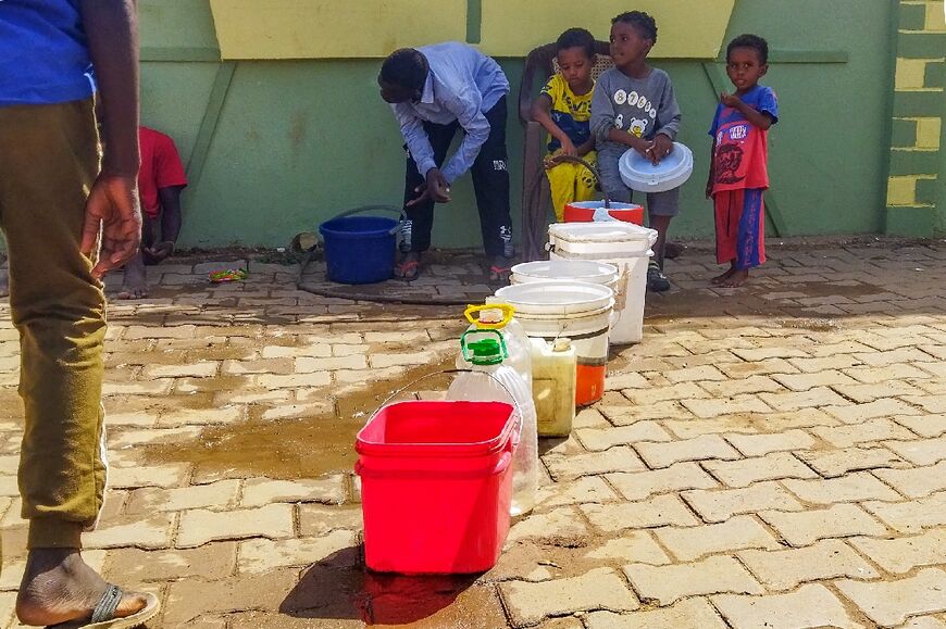 Wad Madani, the capital of Sudan's Al-Jazira state, hosts some of the more than 1.9 million people internally displaced by the war -- here filling containers with water 