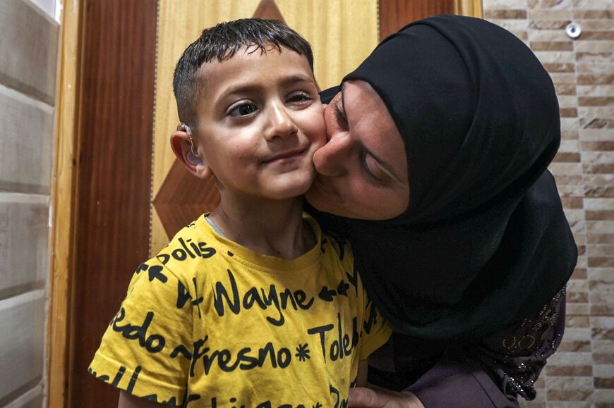 Adam Abu al-Rob with his mother Sabah who usually accompanies him on the visits to an Israeli hospital, with transport provided by Road to Recovery 