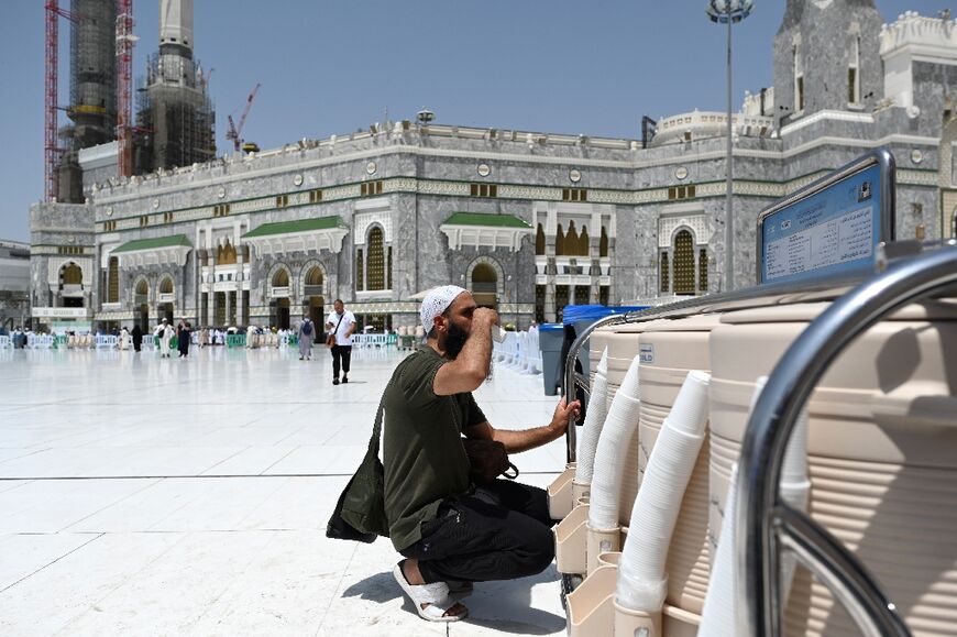 A pilgrim drinks sacred water from the Zamzam spring at the Grand Mosque in Mecca