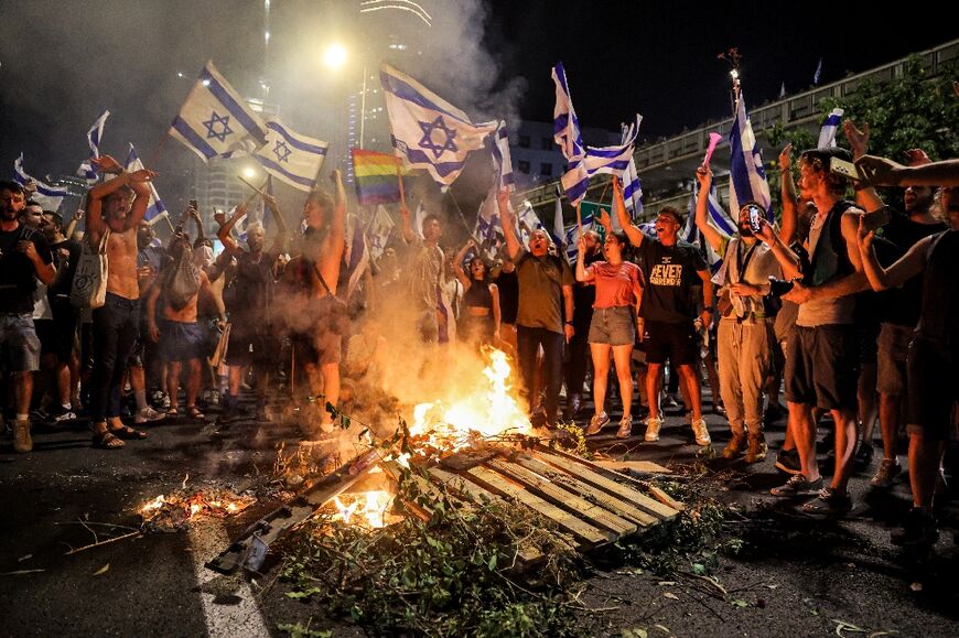 Protesters angry at the passage of a key plank of the government's controversial judicial reforms block a major highway through Tel Aviv