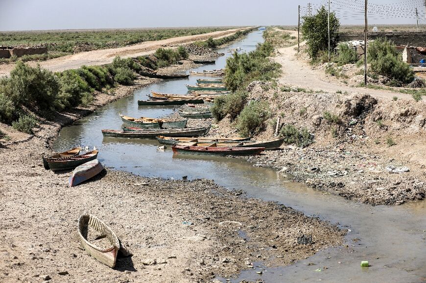 Fishermen's boats lie close to the drying riverbed of the Amshan river in Iraq's southeastern Maysan province