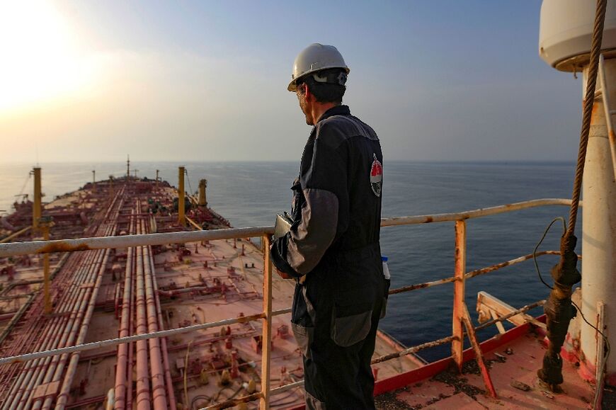 A worker stands on the deck of the abandoned Yemen-flagged FSO Safer oil tanker