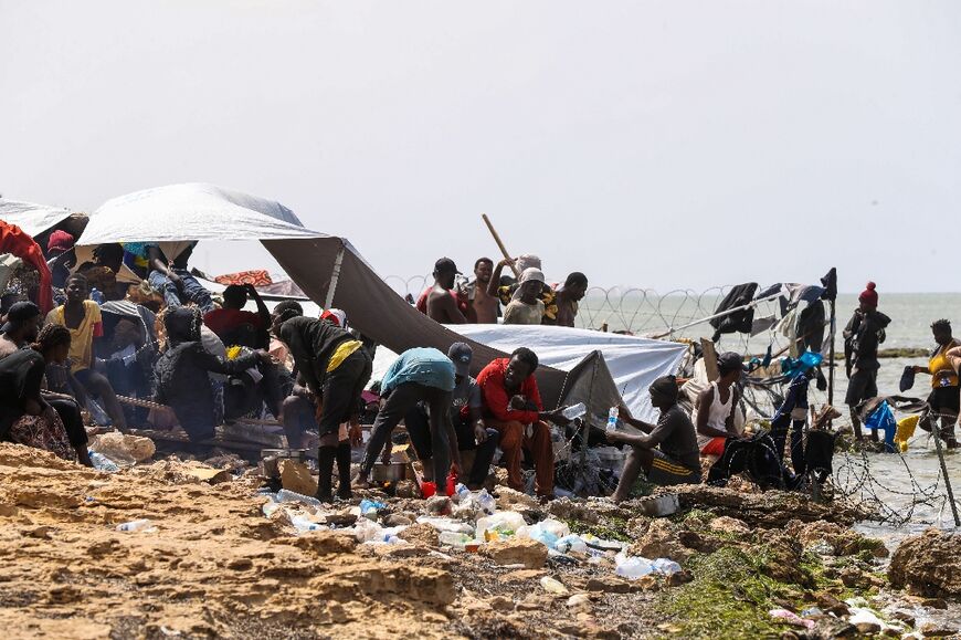 The migrants' makeshift camp near a Libyan border post
