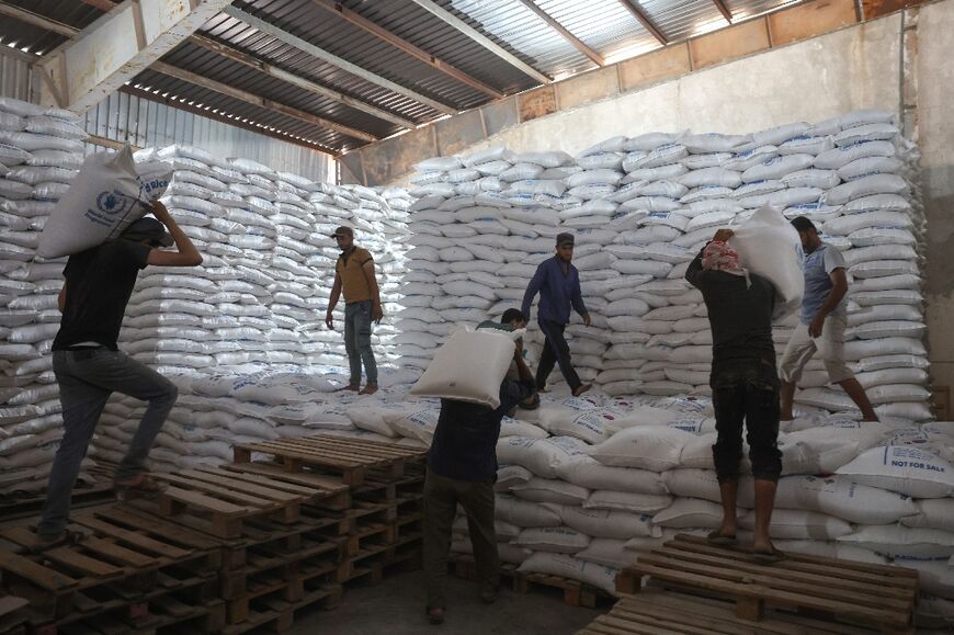 Stacking bags of UN aid at a warehouse near the Bab al-Hawa crossing before Tuesday's Russian veto