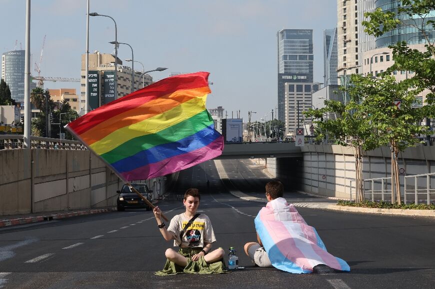 Demonstrators sit on a road in central Tel Aviv during a 'day of resistance' to protest the Israeli government's proposed judicial overhaul