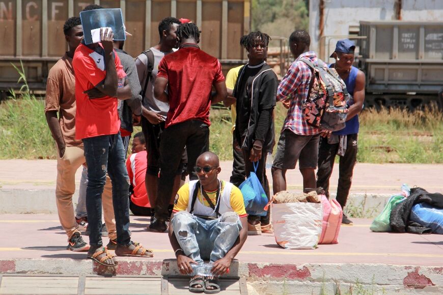 A group of African migrants wait for a train out of Sfax 
