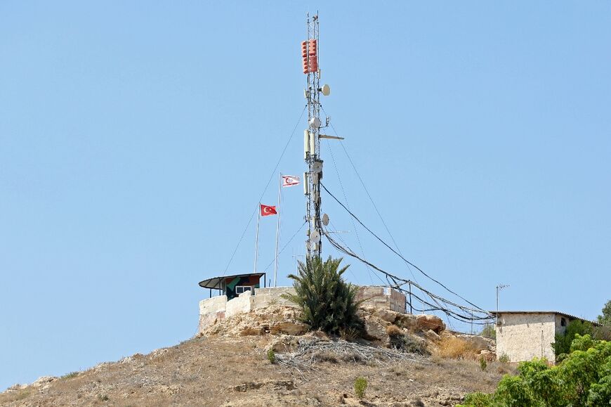Flags of Turkey and the Turkish Republic of Northern Cyprus, recognised only by Ankara, fly in Pyla village, home to both Greek and Turkish Cypriots