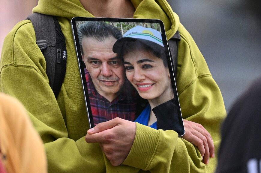 A demonstrator holds a picture of Jamshid Sharmahd, who has been sentenced to death in Iran,a nd his daughter Gazelle Sharmahd in Berlin on July 31, 2023