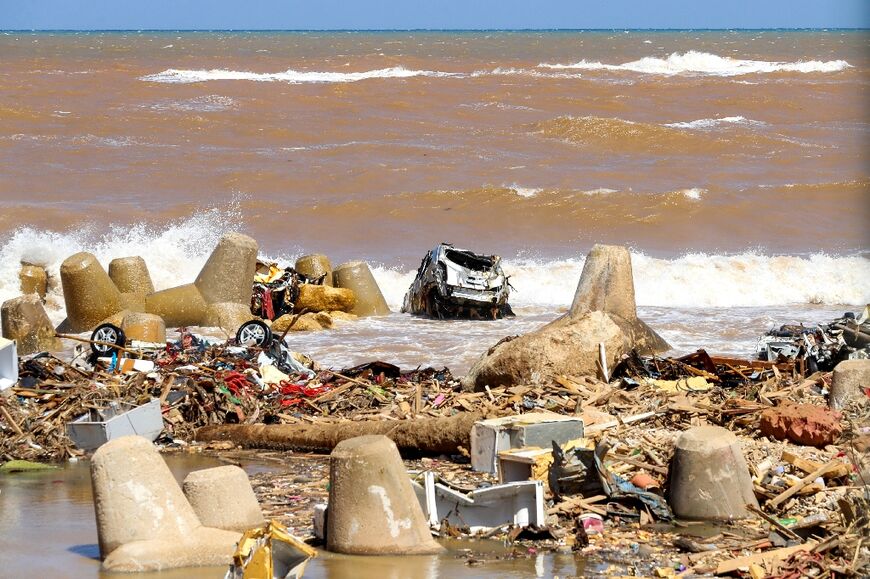 A destroyed vehicle on the sea shore of Libya's eastern city of Derna 