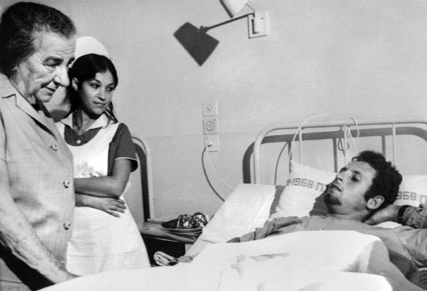 Prime minister Golda Meir, seen here visiting a wounded soldier at a Tel Aviv hospital during the war, resigned in 1974