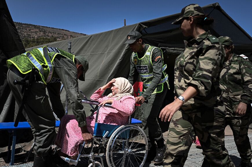 Members of Morocco's auxiliary forces attend to quake survivor in Asni 