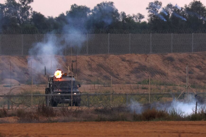 Israeli soldiers fire tear gas towards Palestinian protesters during clashes along the Gaza border