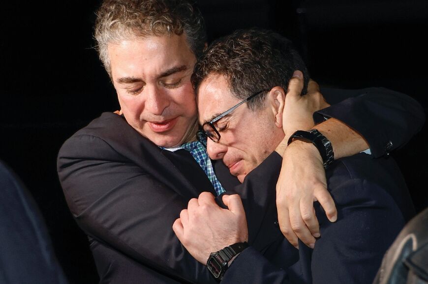 A family member hugs freed US citizen Siamak Namazi (R) upon his arrival at an airbase near Washington on September 19, 2023