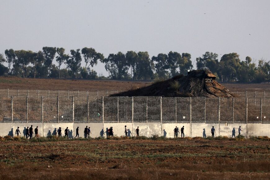 Palestinians protest on Tuesday along the border fence that separates the blockaded Gaza Strip from Israel