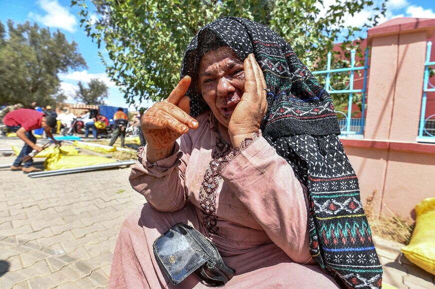 Quake survivor Fatima Oumalloul reacts after receiving a shelter tent 