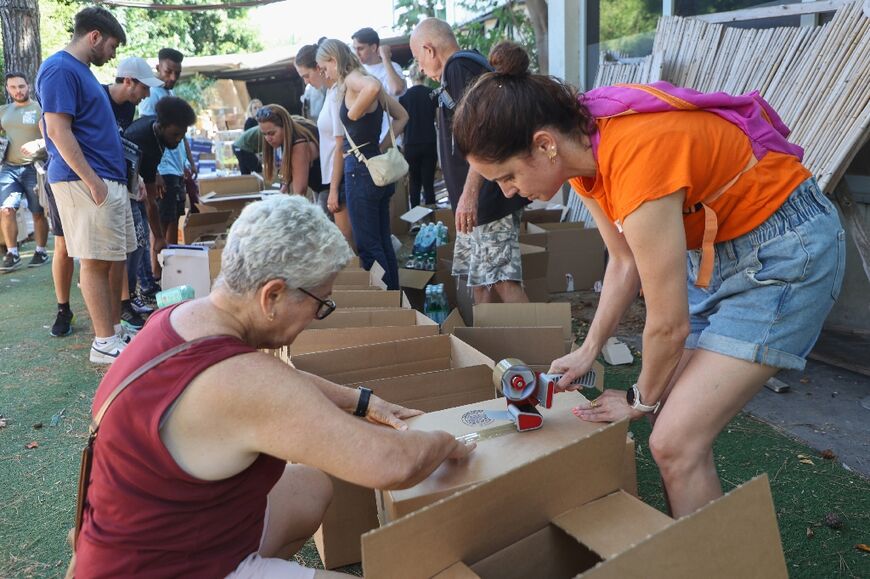 Volunteers, many of them from Israel's protest movement, prepare aid packages for Israeli soldiers and for civilians evacuated from the south after last weekend's shock Hamas attack