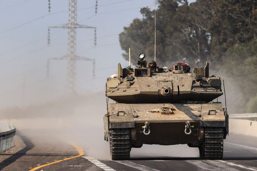 An Israeli tank on a highway near Sderot heads towards Gaza