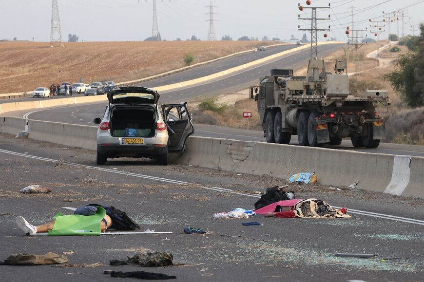 Bodies lie on a main road near the Gevim Kibbutz, close to the border with Gaza on October 7