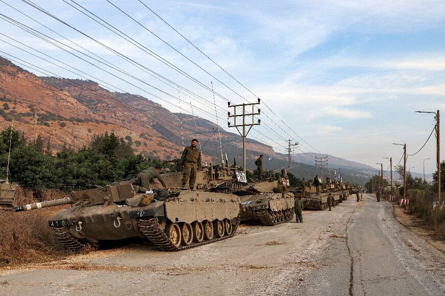A column of Israeli Merkava battle tanks are deployed in the Galilee region of northern Israel near the Lebanon border