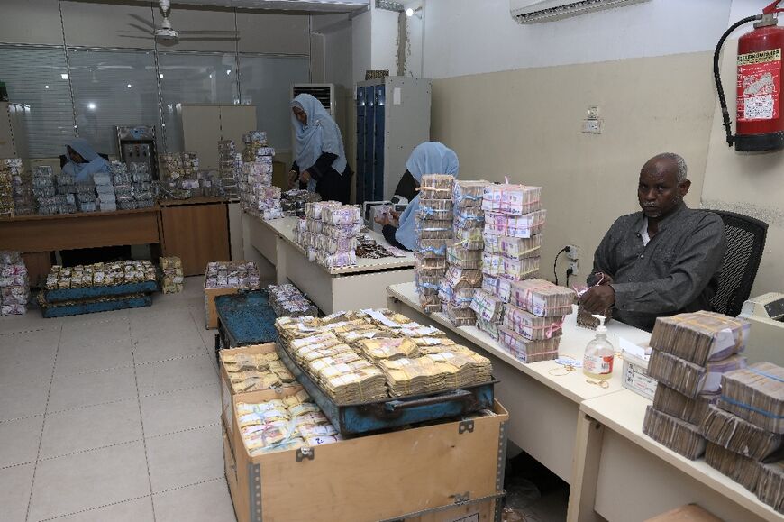 Employees count bills at the Central Bank in Port Sudan, which has long been the country's second largest commercial centre