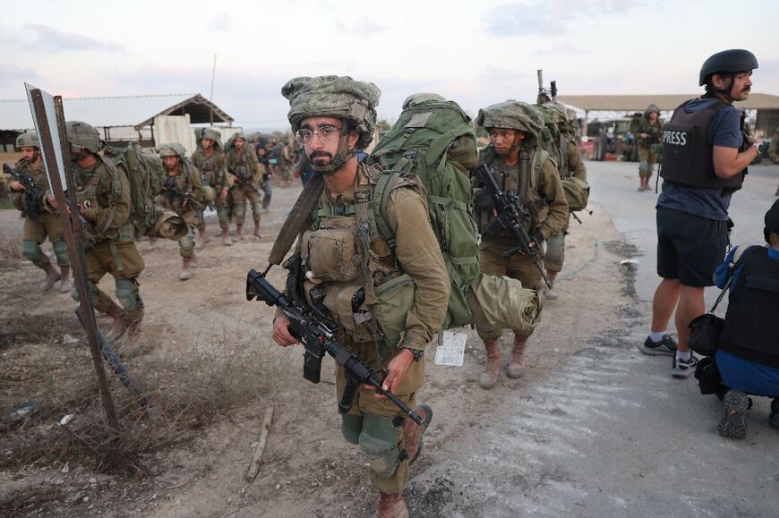 Israeli soldiers deploy at kibbutz Beeri on Wednesday