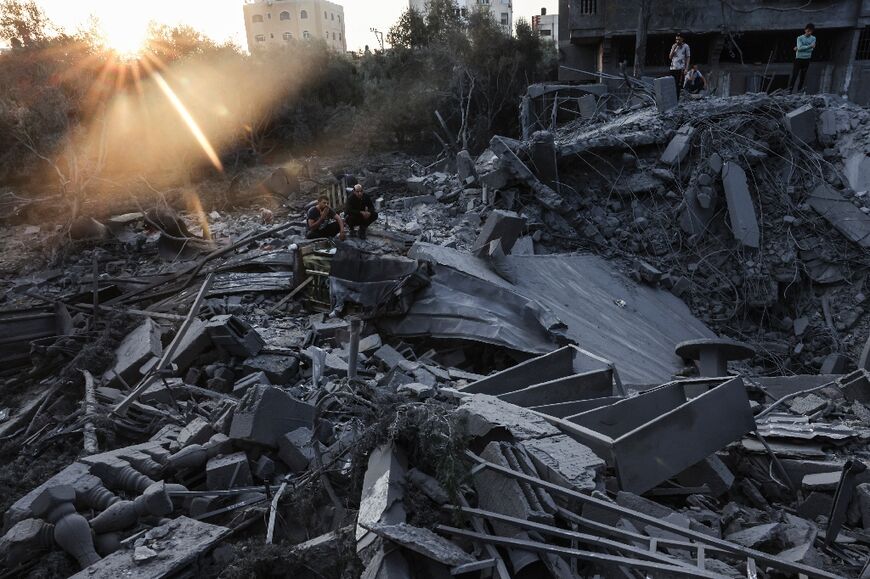 People inspect the damage to their home after Israeli strikes in the Rafah camp in southern Gaza