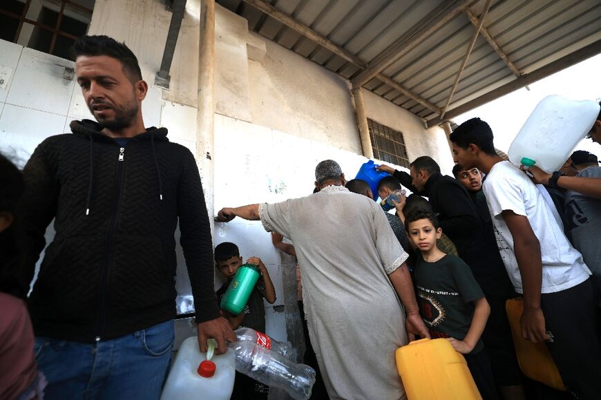 Palestinian queue to fill containers with water in Khan Yunis in the southern Gaza Strip
