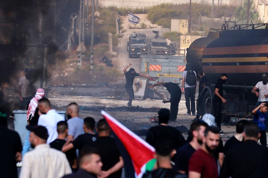 Palestinians clash with Israeli soldiers near the Palestinian city of Ramallah in the occupied West Bank on October 13, 2023