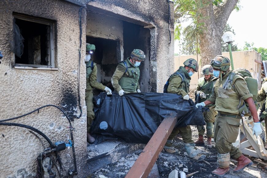 Israeli forces say Palestinian militants set fire to houses in Kfar Aza to force their Israeli occupants out but many died inside their homes