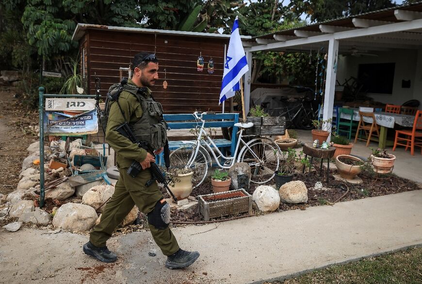 An Israeli soldier in Kibbutz Kfar Aza, which was attacked by Hamas militants, close to the southern Israeli border with the Gaza Strip on October 27, 2023