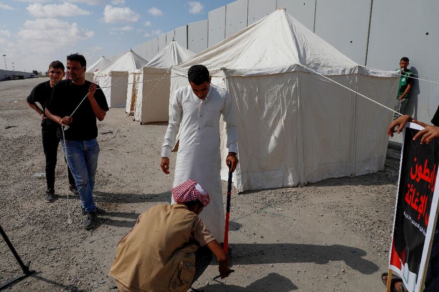 Volunteers and NGO workers set up tents along the Egyptian side of the Rafah border crossing