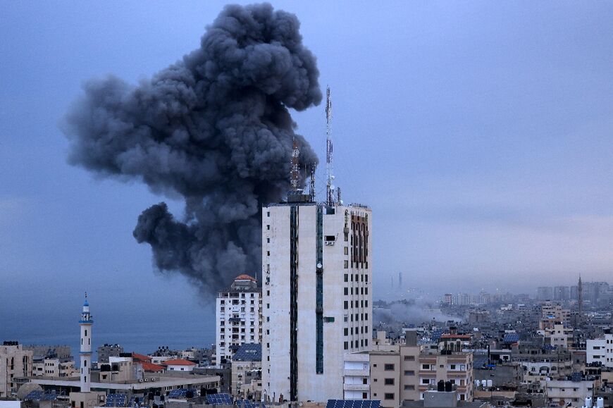 Smoke rises above buildings during an Israeli air strike, in Gaza City on October 9, 2023