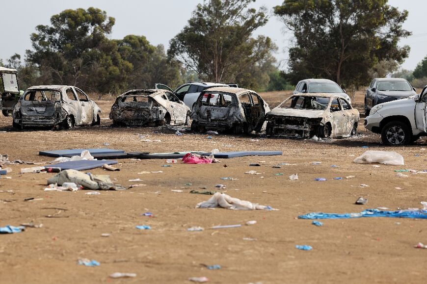Burnt cars are left behind at the site of a rave party which came under attack by Palestinian militants