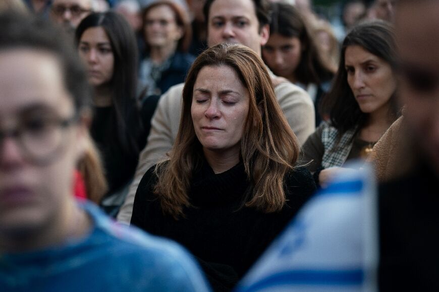 A person cries during a prayer service and candlelight vigil for Israel at Temple Emanu-El in New York City on October 9, 2023, after the Palestinian militant group Hamas launched an attack on Israel