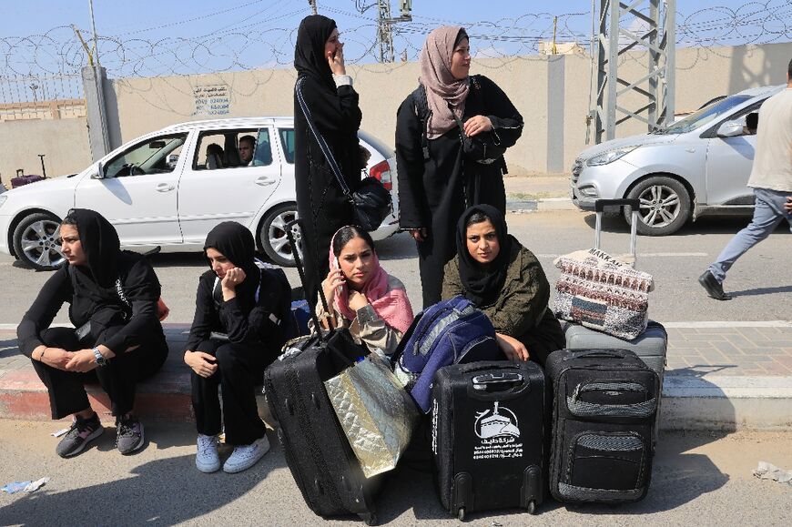 Palestinians with foreign passports are waiting at the Rafah border crossing controlled by Egypt