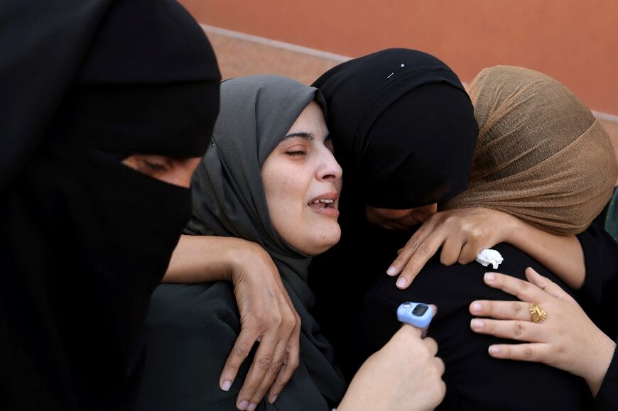 Palestinian women grieve as the bodies of relatives are collected for burial from the al-Nasser hospital in Khan Yunis in the southern Gaza Strip on November 9, 2023
