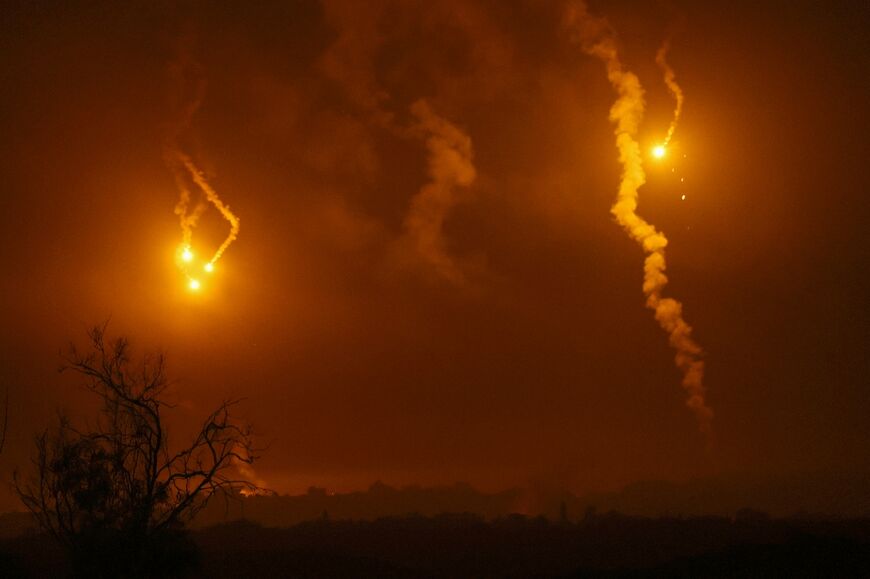 This picture taken from a position along the border with the Gaza Strip in southern Israel shows flares launched by Israeli forces above the north of the Palestinian territory amid ongoing battles with the militant group Hamas, on November 14, 2023.